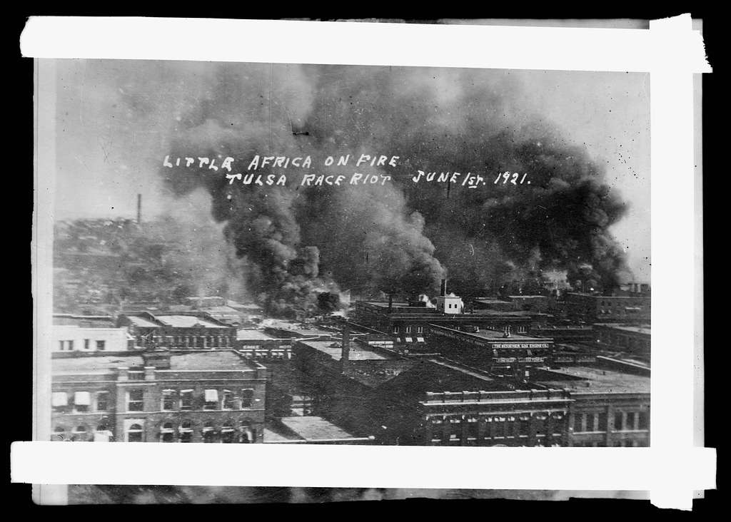 Image shows burning buildings during the Tulsa Race Massacre in Oklahoma