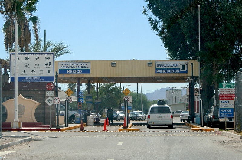 Image shows a car driving through the border into Sonoyta Mexico from Lukeville, Arizona