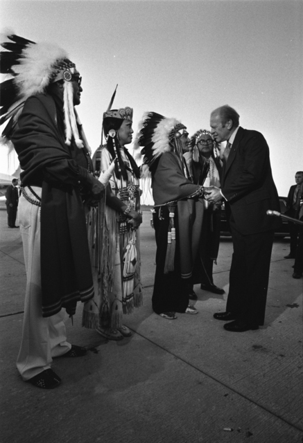 Image shows President Gerald R. Ford shaking the hands of Kiowa Tribal Chairman Big Bow and three other American Indian leaders