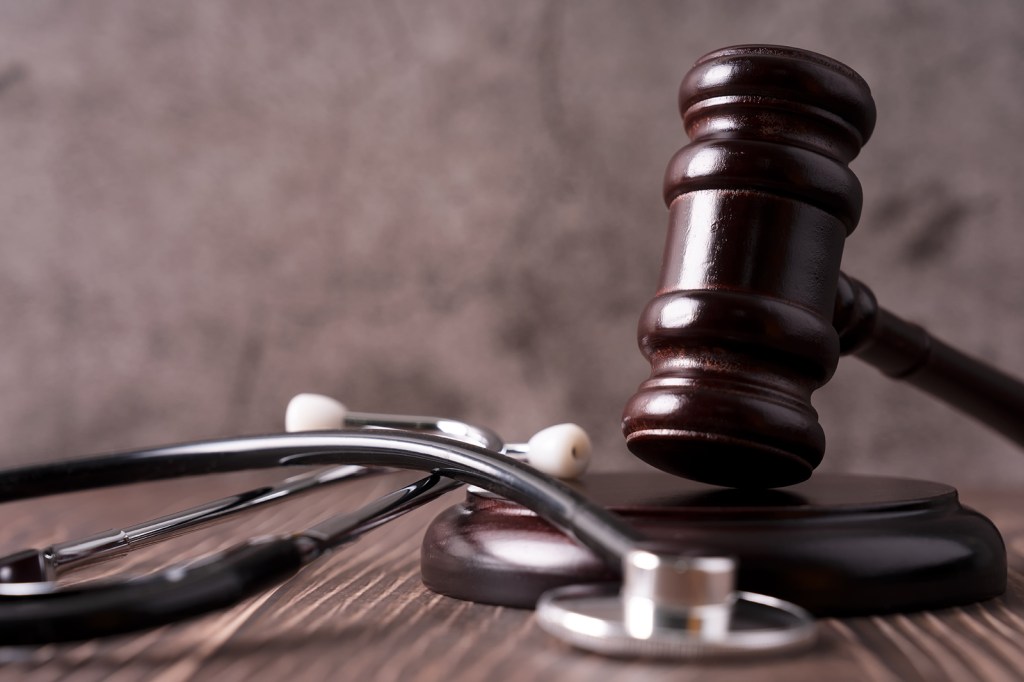A photograph of a gavel and a stethoscope