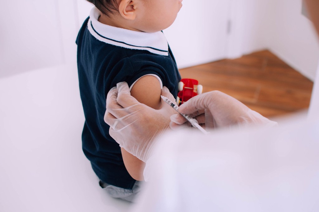 Photo of a toddler being administered a vaccination