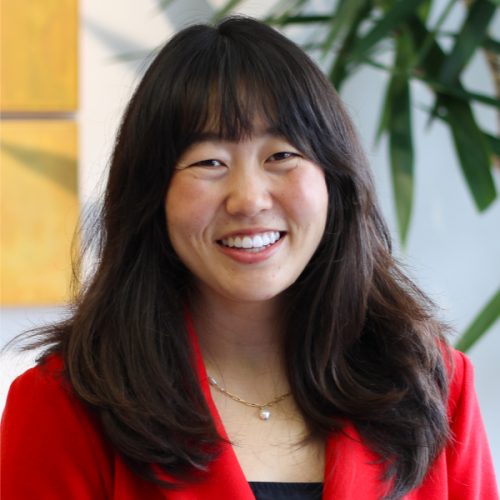 Professional headshot of Ashley Mizuo in a red blazer.