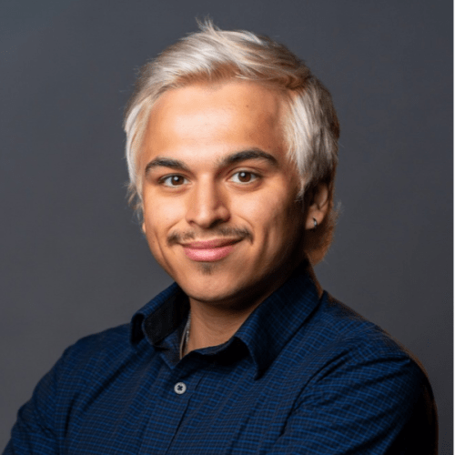 Professional headshot of Anthony Montano in a navy button up against a dark gray background.
