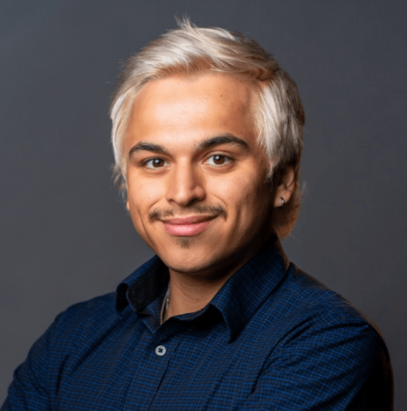 Professional headshot of Anthony Montano in a navy button up against a dark gray background.